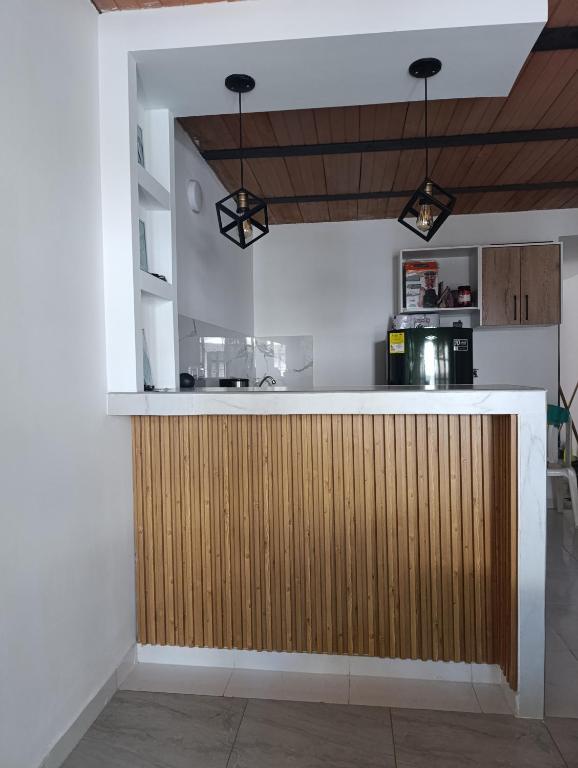 a kitchen with a wooden bar in a room at Apartamento comodo in Cali