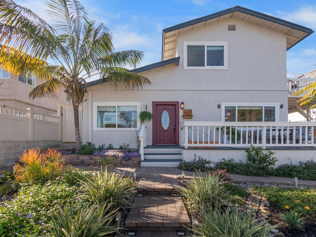 Luxe OB Home, Walk to Beach, Sauna, and Backyard في سان دييغو: منزل فيه باب احمر و نخله