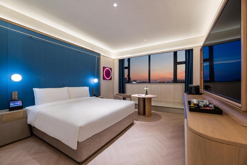 Cama o camas de una habitación en Crystal Orange Hotel Foshan Jinshazhou Jinbo Tiandi Store