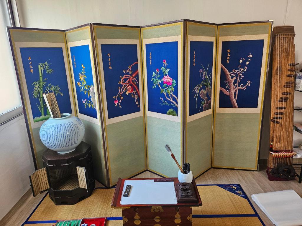 a room with paintings of fishes and a table at Romantic Winter Package , K-Culture Experience Itaewon 7min,2F Korean Culture Zone ,Terrace , K-Ramen Challenge in Seoul