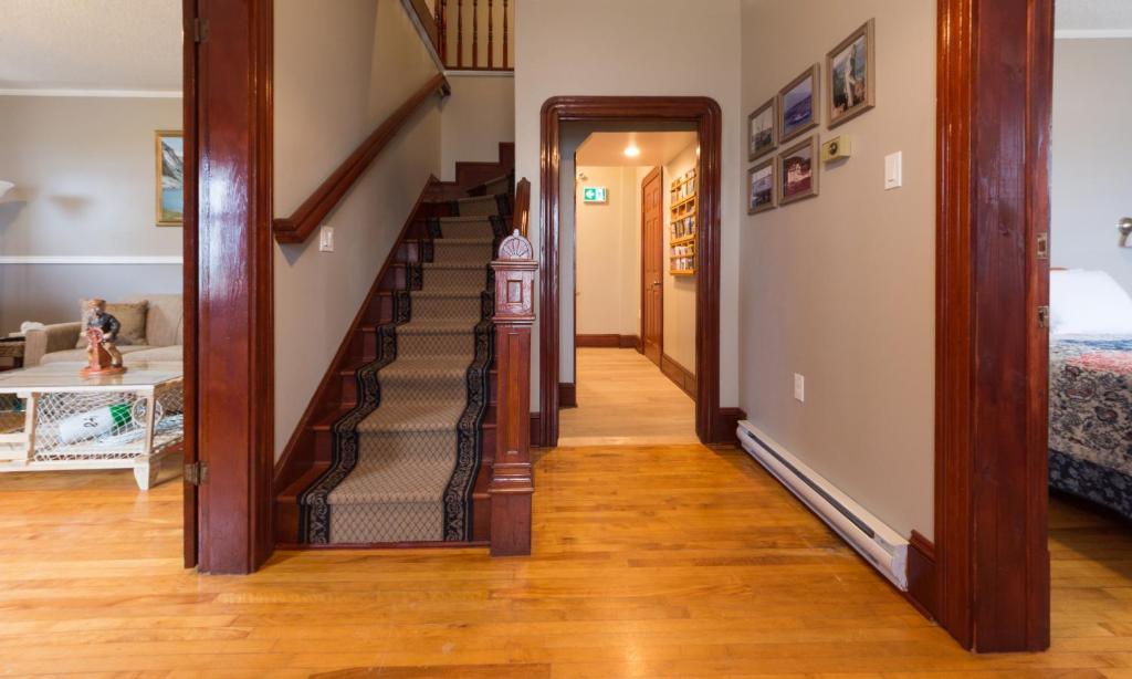 a hallway with a staircase in a home at The Archie & Isidore Hotel in Chéticamp