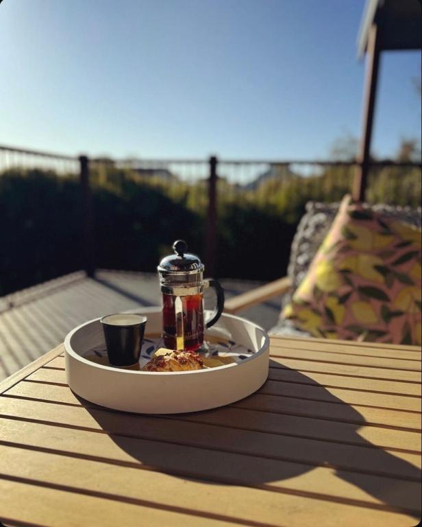 a tray with a tea pot and a cup on a table at Yarrimbah Relaxed Coastal Getaway in Capel