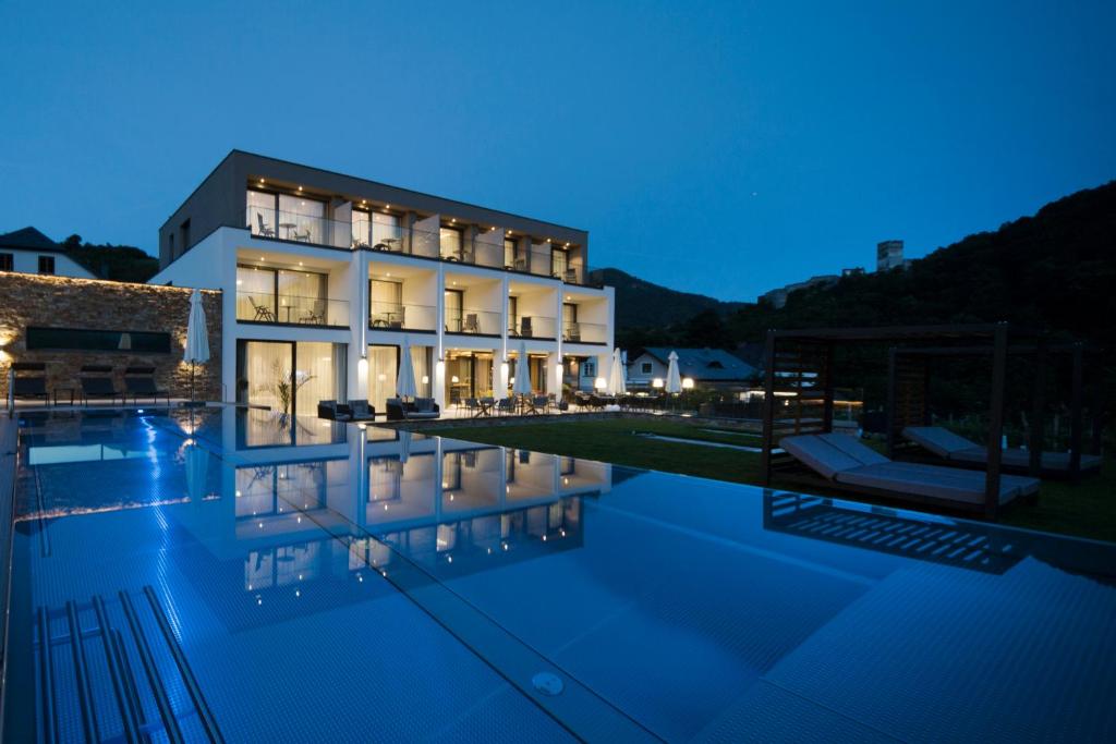 a villa with a swimming pool at night at Weingut Donabaum "In der Spitz" in Spitz