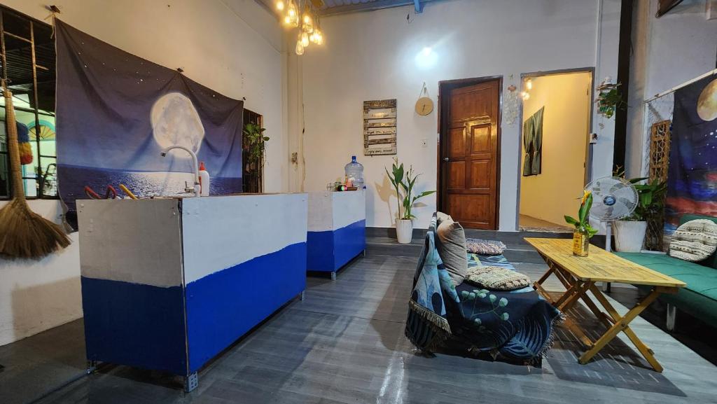 a room with a bar with a couch and a table at LoCo House in Con Dao