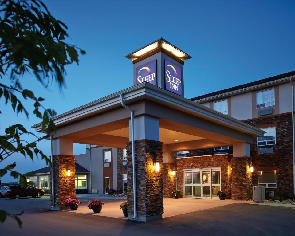 a building with a sign on top of it at Sleep Inn Regina East in Regina