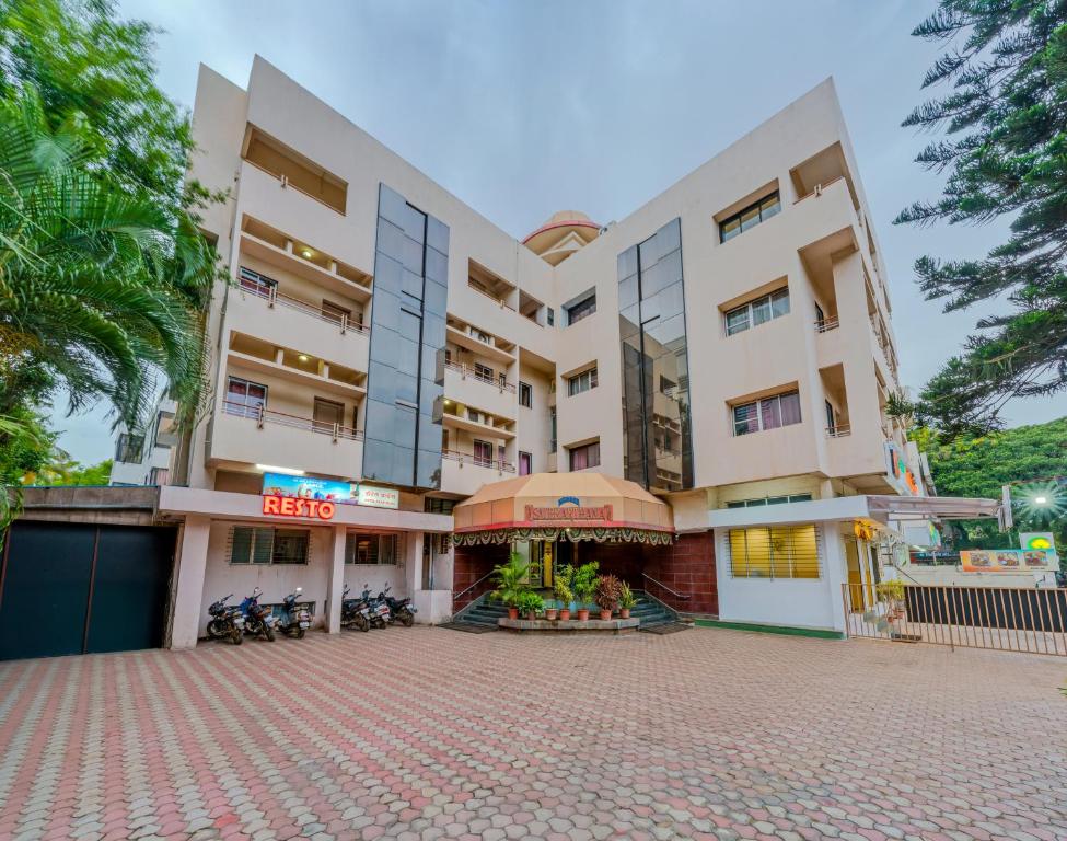 a building with motorcycles parked in front of it at Hotel Sai Prarthana Inn in Sangli