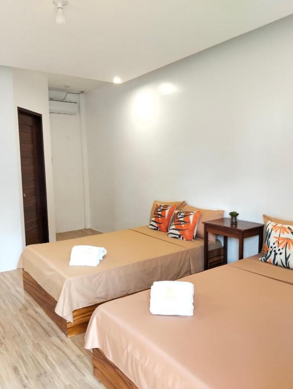 a room with two beds and a table at Malibhu View Resort in Carmen