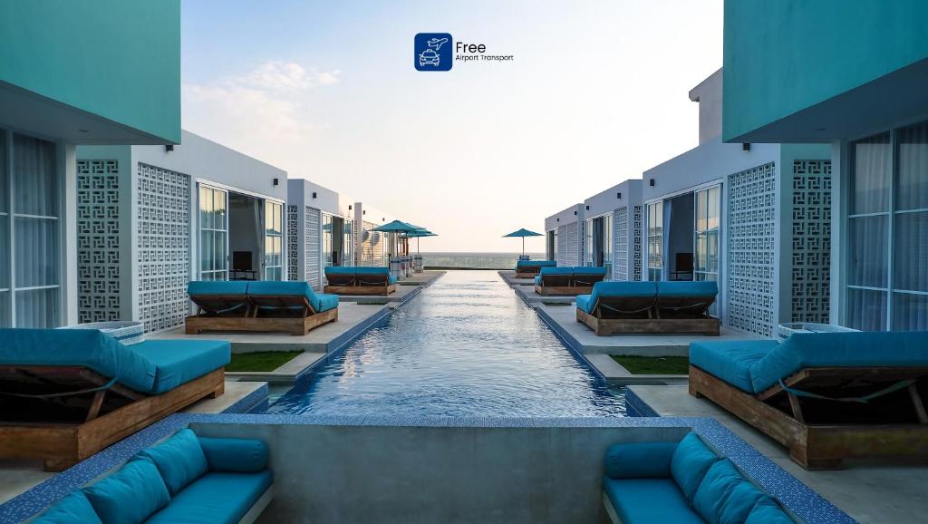 a swimming pool in the middle of a building at Abian Kapas Beach House in Tabanan