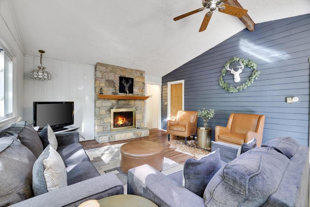 a living room with a couch and a fireplace at Pet Friendly Lake Retreat With Hot Tub & Fire Pit in Locust Lakes Village