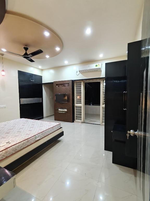 a bedroom with a bed and a ceiling fan at 3BHK Spacious Villa in Pune