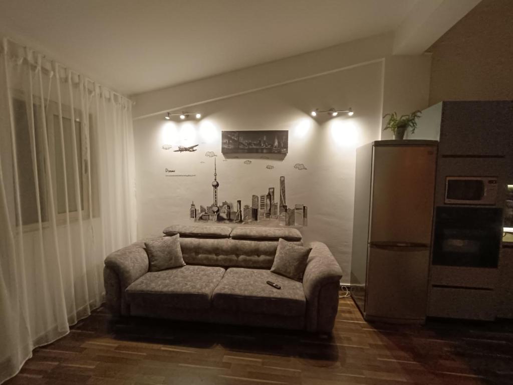 a living room with a couch and a refrigerator at Noah's Seaside in Golem
