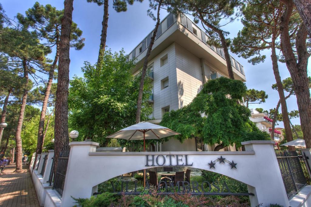 a hotel building with trees in front of it at Hotel Villa Ombrosa in Milano Marittima