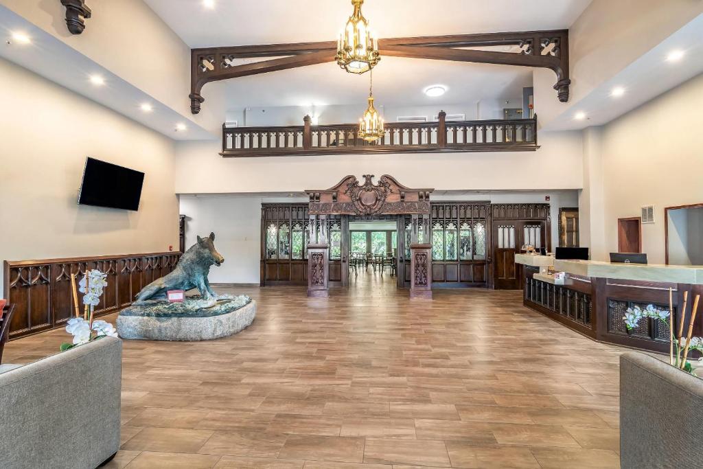 an empty lobby with a statue in the middle of the room at Riverview Inn & Suites, an Ascend Collection Hotel in Rockford