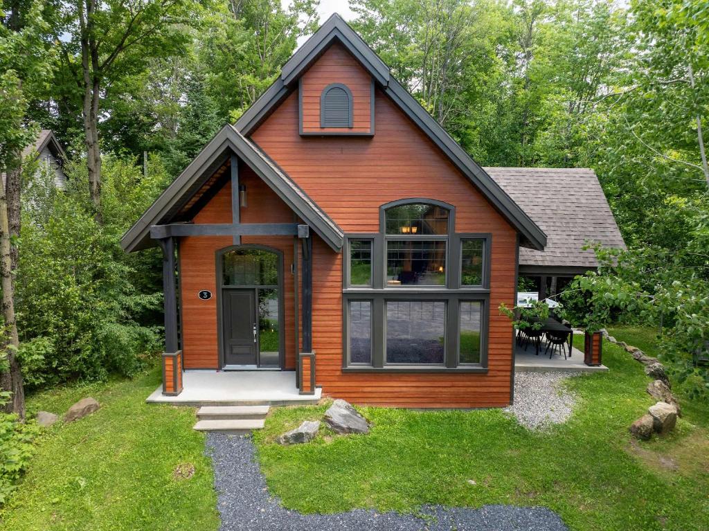 a tiny house with a large door in a yard at Spa & Pool table - Ivy Cottage in Scott