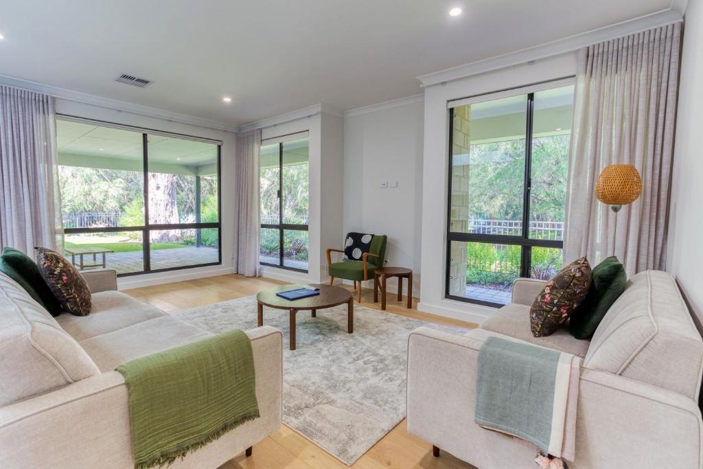 a living room with two couches and windows at Peppermint Breeze in Vasse
