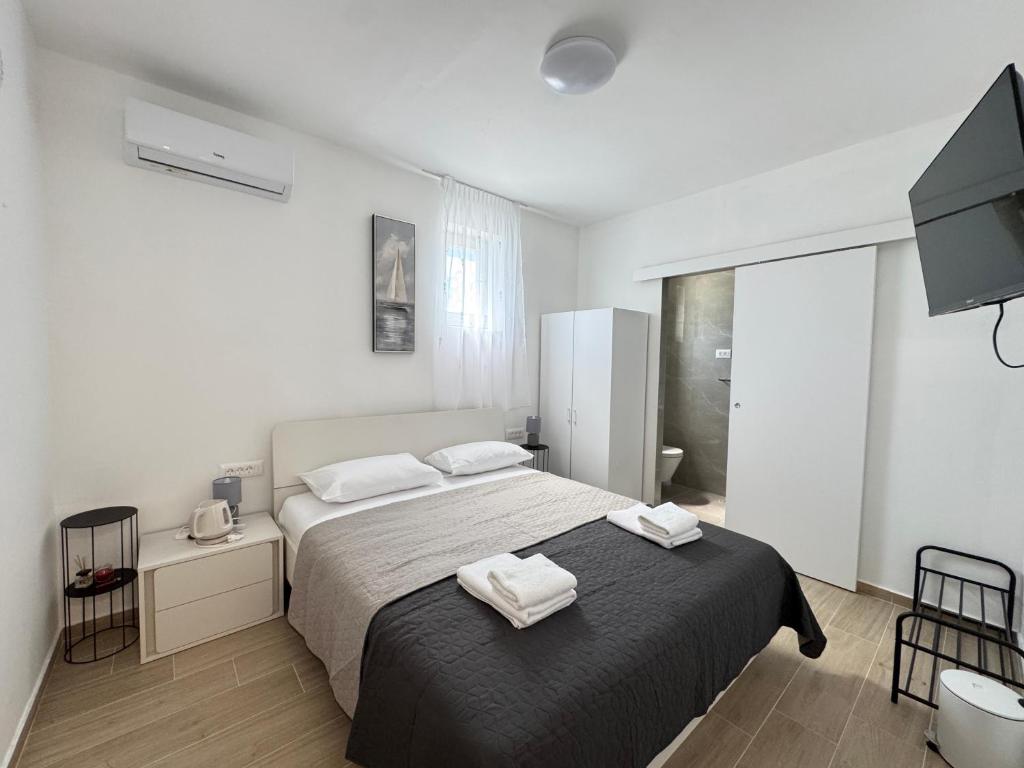 a bedroom with a bed with two towels on it at Flowers Apartments Pula, city center 2 in Pula