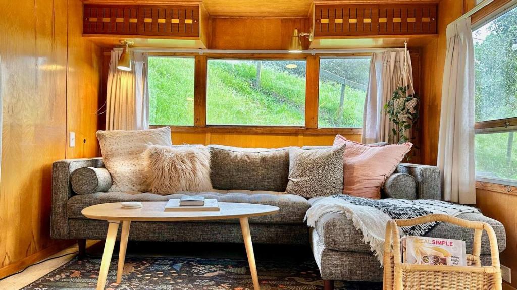 a living room with a couch and a table at Vintage Spartan-retro Farm Stay W Ev Charger in Arroyo Grande