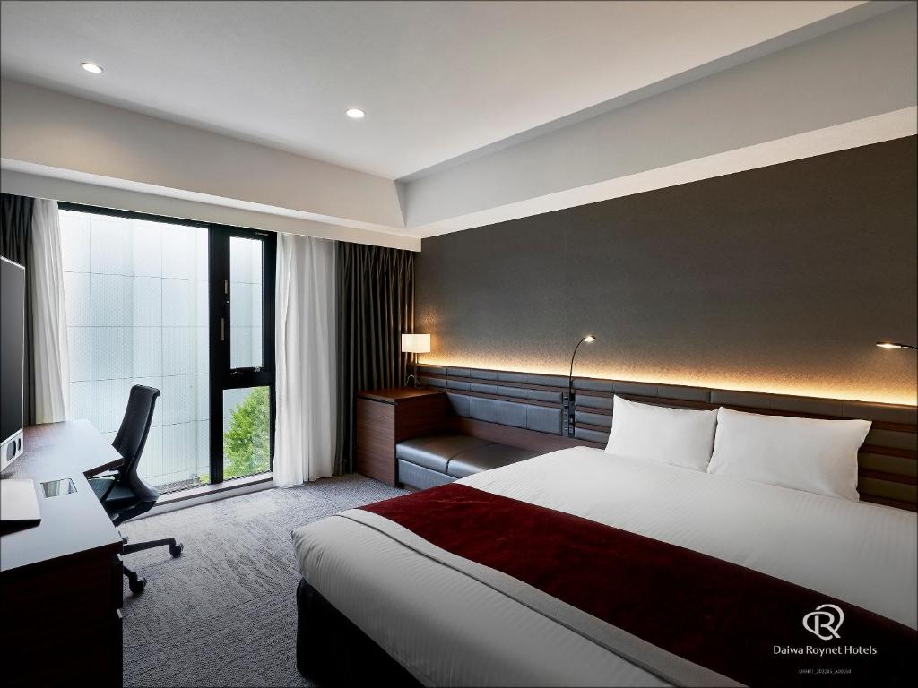a hotel room with a bed and a desk and window at Daiwa Roynet Hotel Sendai Ichibancho PREMIER in Sendai