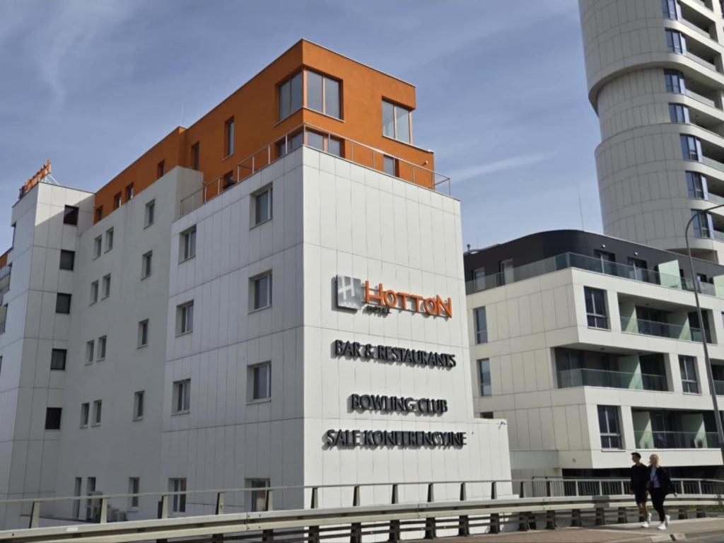a building with a sign on the side of it at Hotton Hotel in Gdynia