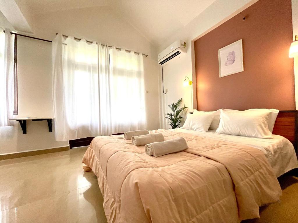 a bedroom with a large bed with two pillows on it at The Driftwood Dan Studio Flat Colva, anirah in Colva