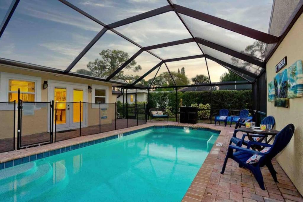 a swimming pool with a glass roof over it at On Island! Private Pool Home-Walk to Great Beach! in Venice