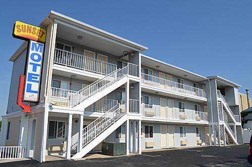 a building with a hotel sign in front of it at Sunset Motel in Seaside Heights