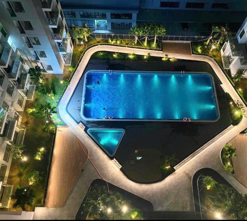 a swimming pool in the middle of a building at night at TY'S Homestay Nera Garden Hue in Thôn Văn Dương