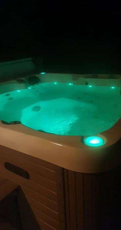 a jacuzzi tub with green lights on it at Spacious on Sarita in Cromwell