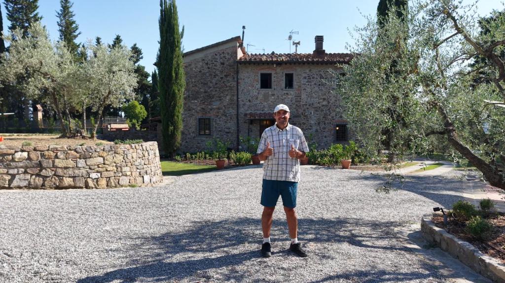 a man standing in front of a house at Agriturismo Amici Miei in Lastra a Signa