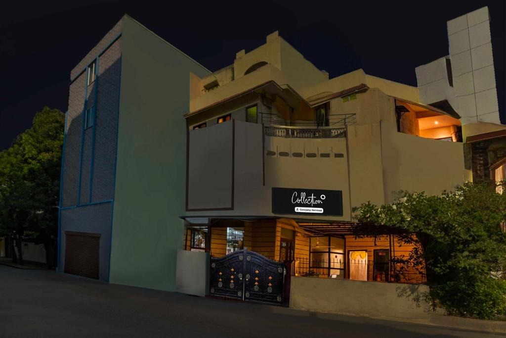 a building with a sign on the side of it at night at Townhouse Oak Begumpet Railway Station in Hyderabad