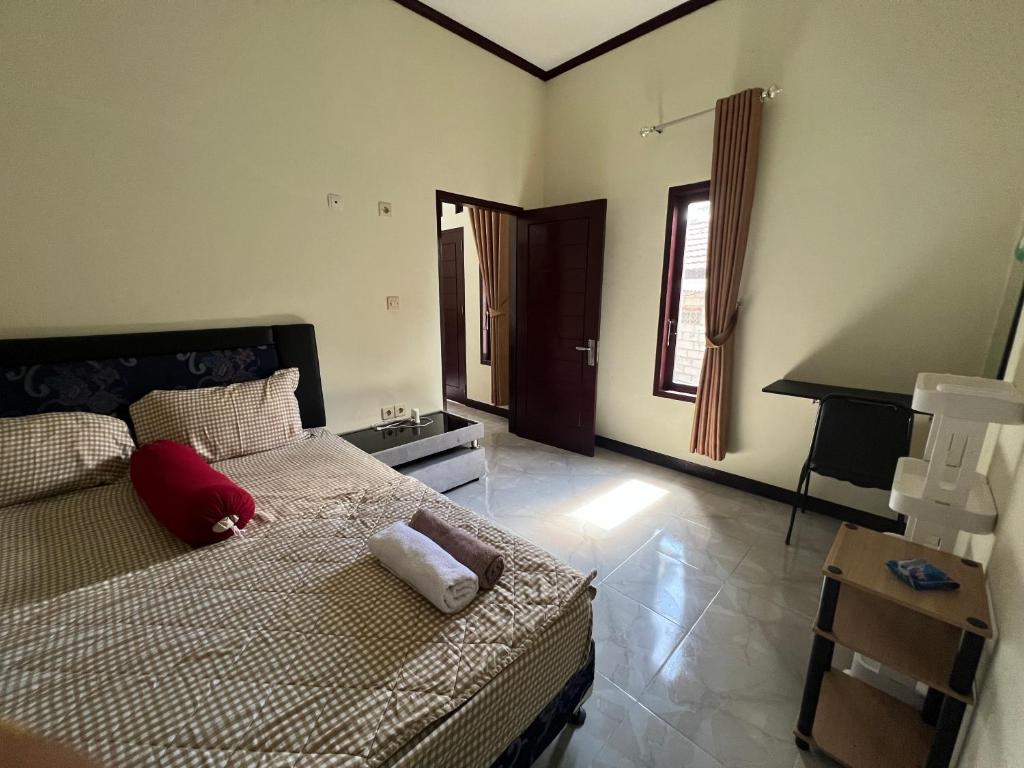 a bedroom with a bed with two towels on it at Parkside nest-studio 3 in Kuta Lombok