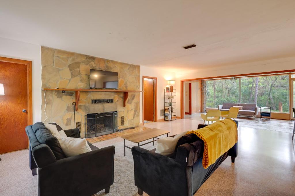 a living room with two couches and a fireplace at Vacation Home Rental in Gainesville, Florida! in Gainesville