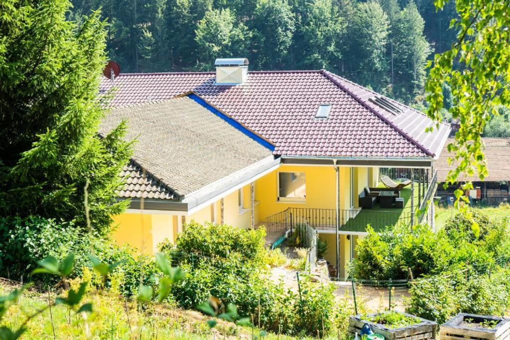 a yellow house with a red roof at Whirlpool, Billiard, Sauna! Ferienhaus Lacher in Baiersbronn