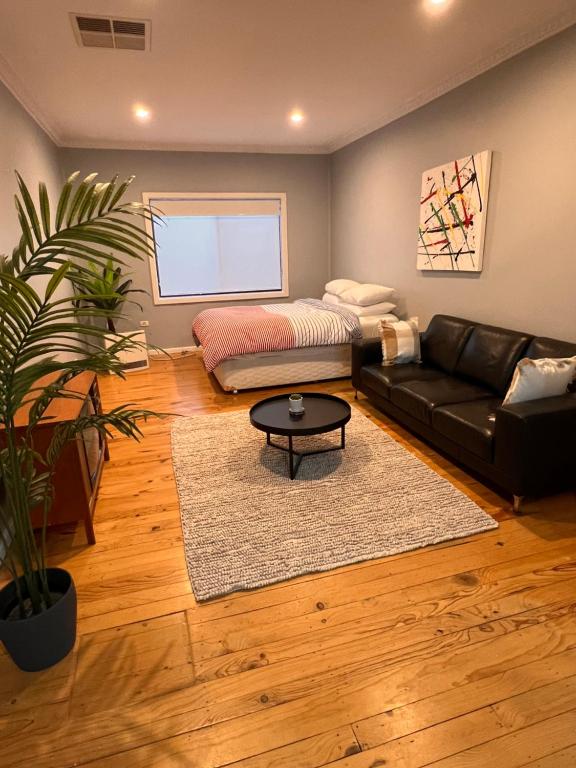 a living room with a couch and a table at Urban Studio in Queanbeyan