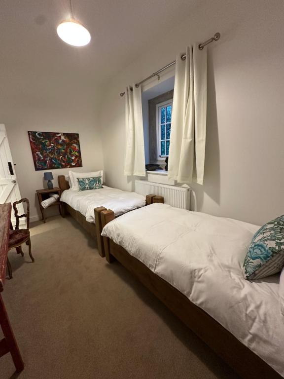 アシュボーンにあるOverfield Farmのベッド2台と窓のある寝室