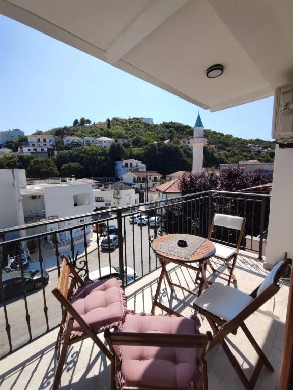 a balcony with chairs and a table and a view at Guesthouse Nesa in Ulcinj