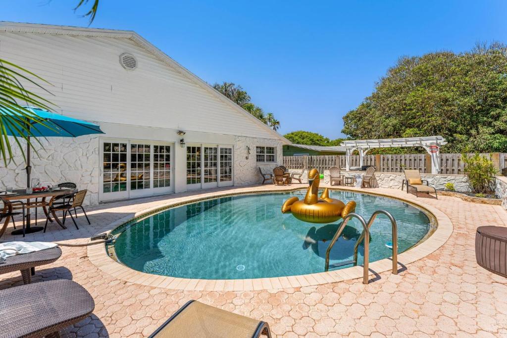 a swimming pool with a fountain in a yard at 218 Fifth Avenue in Melbourne Beach