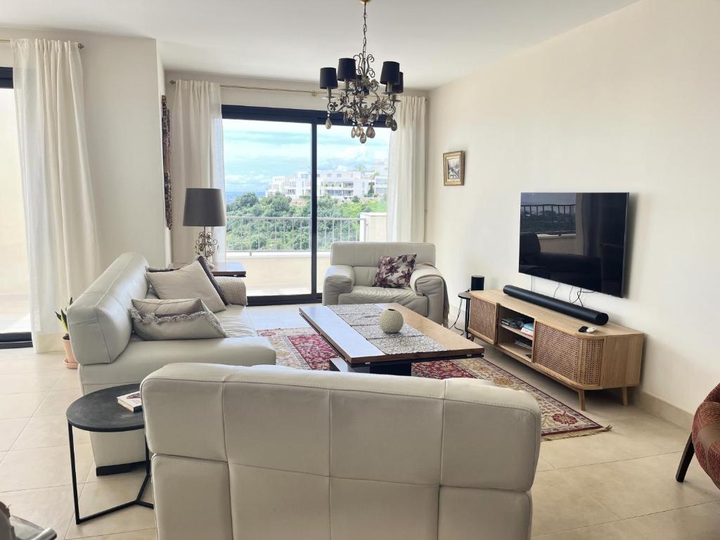 a living room with a couch and a tv at Luxury Penthouse for lifelong memories in Marbella