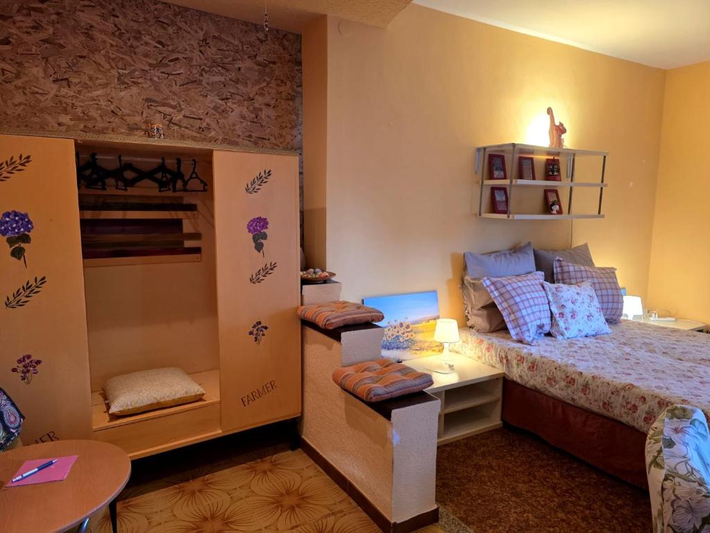 a small bedroom with a bed and a table at Casetta il Melograno Cozy two-room apartment to the Sea in Villaggio Mosè