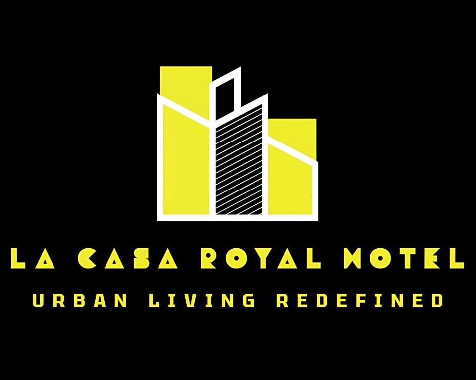 a yellow and white logo with a building at La Casa Royal Hotel 