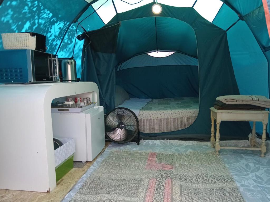 a bedroom with a bed in a tent at Tenda campismo 47 A Retiro dos sonhos in Lagoa