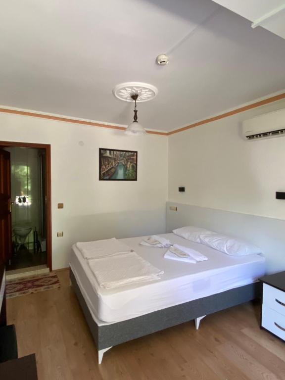 a bedroom with a large bed in a room at Plaj Hotel in Cıralı