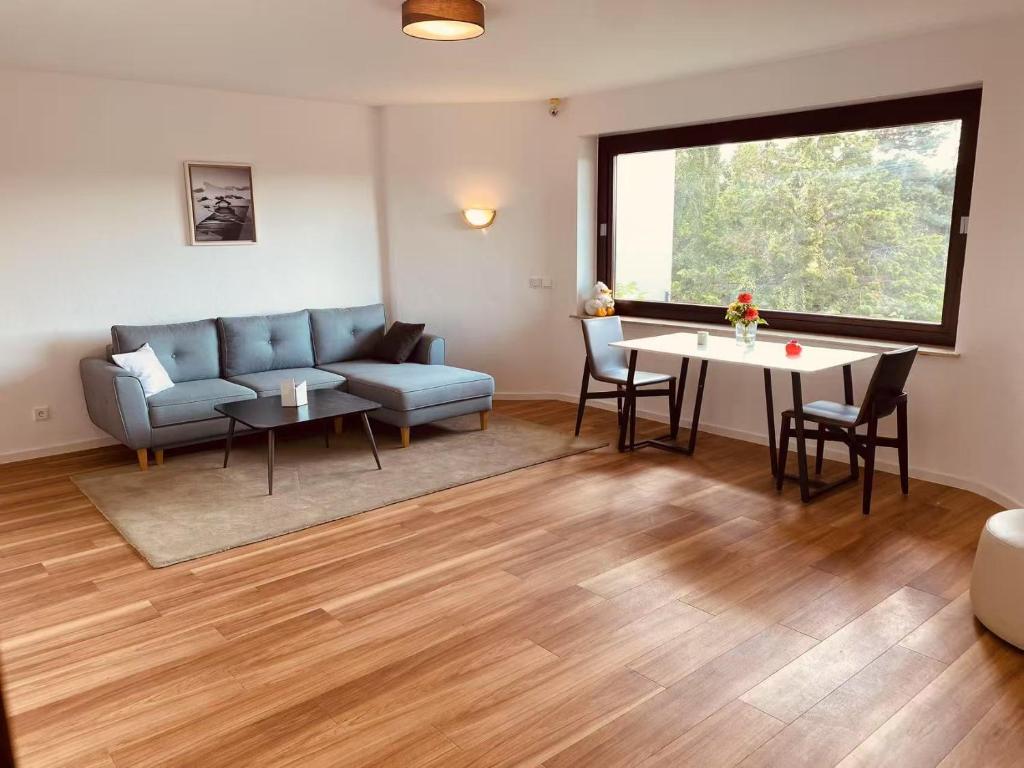 a living room with a couch and a table at Helles Apartment Bergblick Nähe Messe Frankfurt in Bad Soden am Taunus