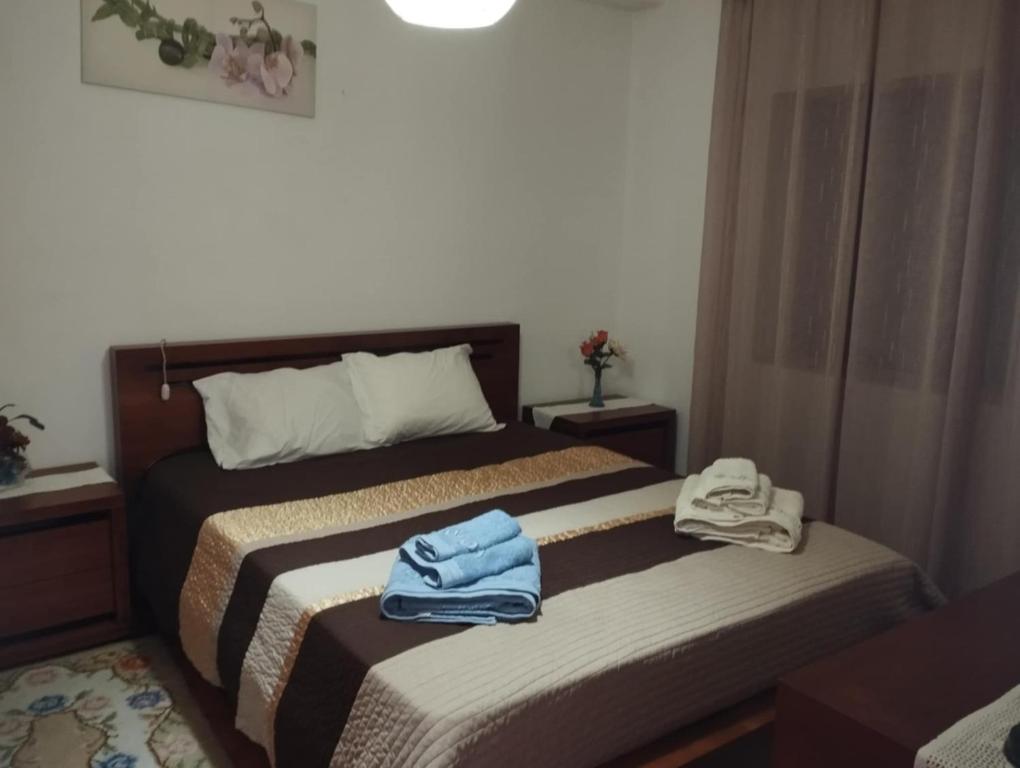 two beds in a hotel room with towels on them at Esposende Private Terrace Flat in Outeiro