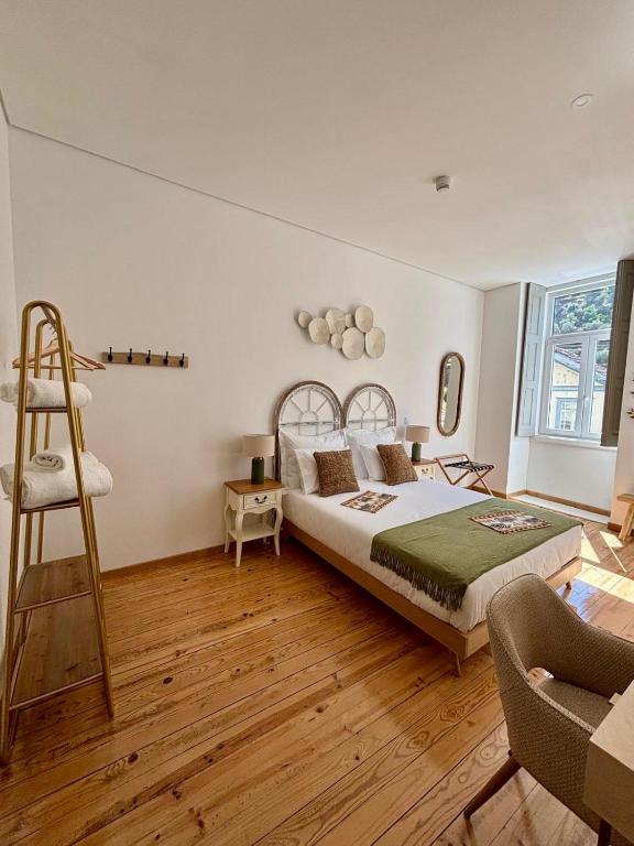 a bedroom with a bed and a ladder in it at Casa Tawny in Pinhão