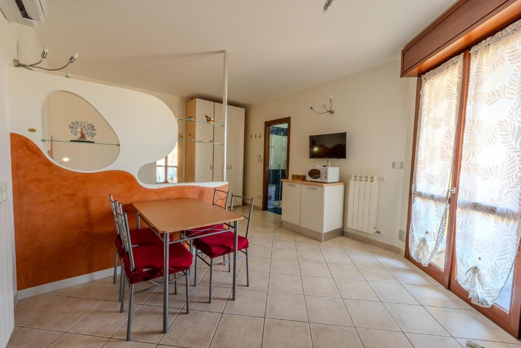 a dining room with a table and chairs at Turin Airport apt I in Leinì