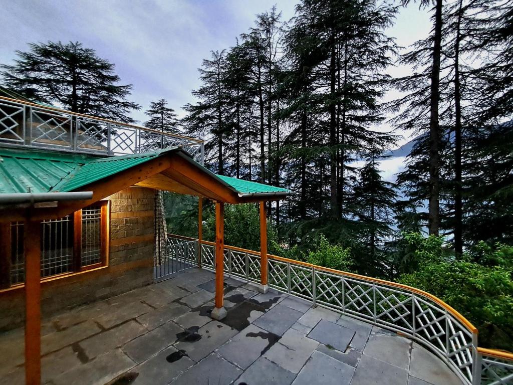 a balcony of a house with a green roof at Shantiloka - Private 1BHK Homestay in Kulu