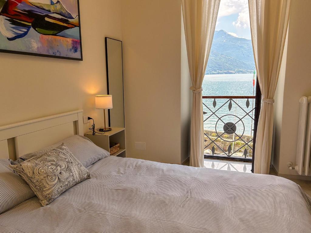 a bedroom with a bed and a view of the ocean at Giulia in Dongo