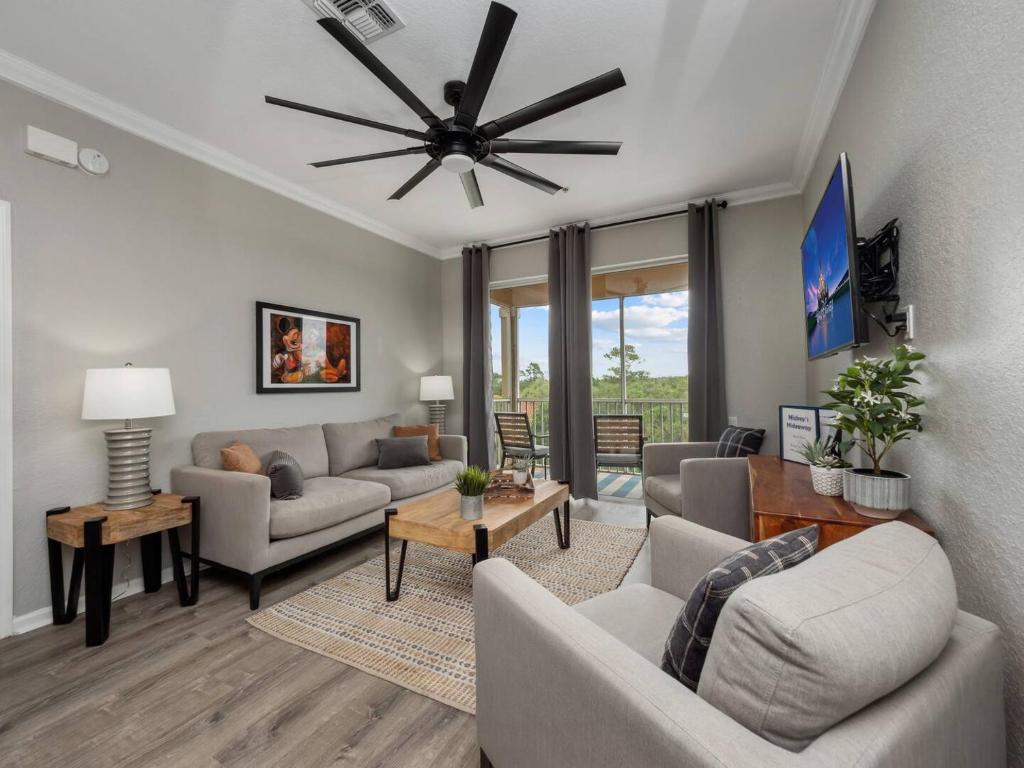 a living room with couches and a ceiling fan at Mickey's Hideaway Windsor Hills Resort in Orlando