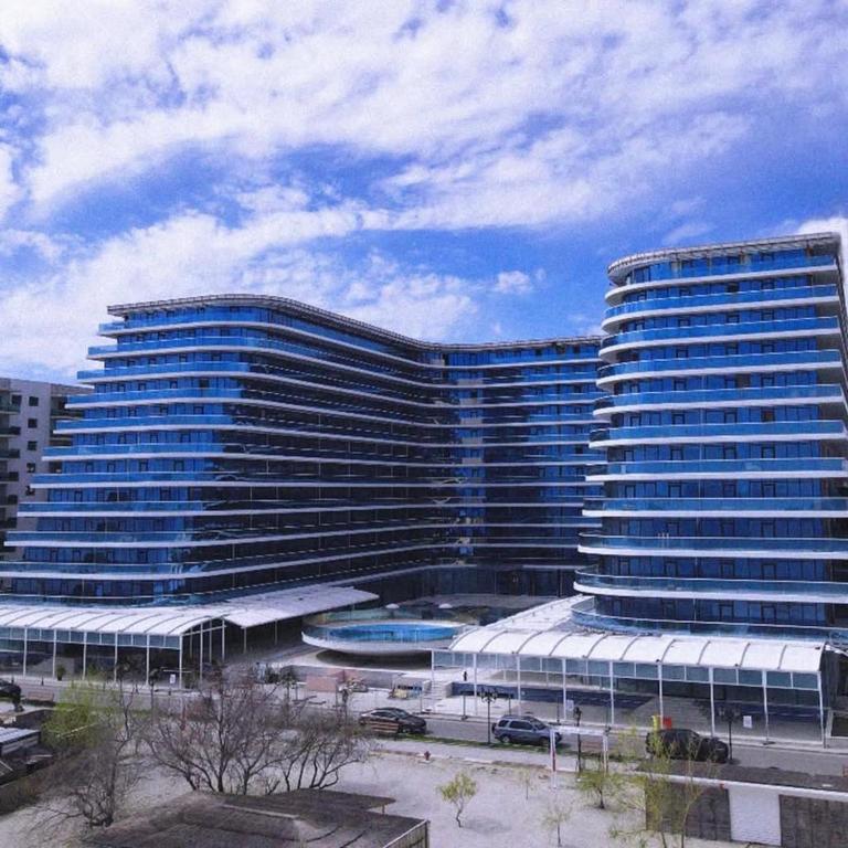 a large building with a pool in front of it at White Titanic -Luxury Turism in Mamaia Sat/Năvodari